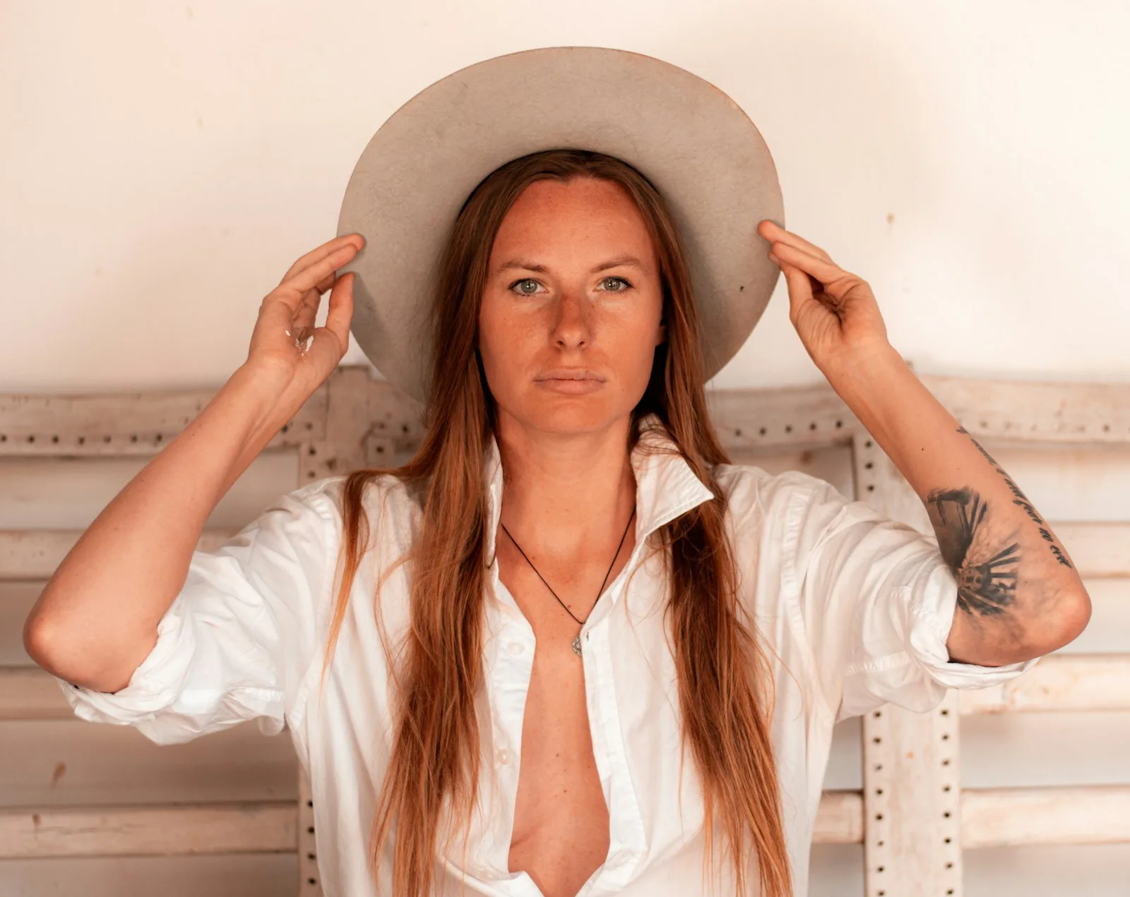White western shirt worn open-collar with a wide-brim hat