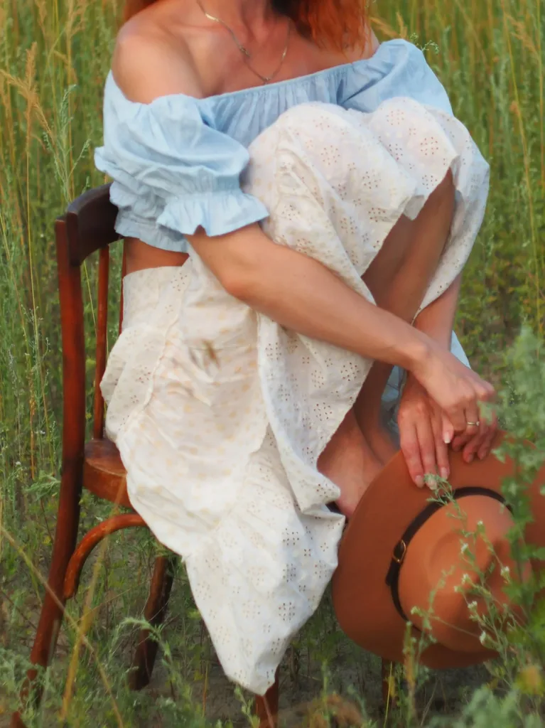 Tiered eyelet prairie skirt with an off-shoulder top and felt hat