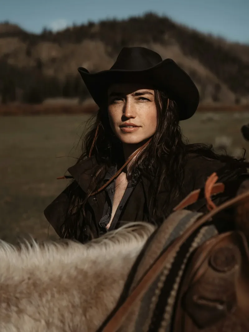 Black felt cowgirl hat worn horseback in the foothills
