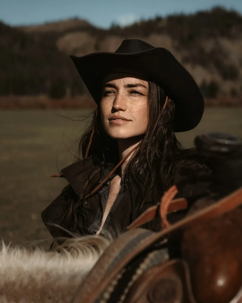 Black felt cowgirl hat, mountain light, close portrait