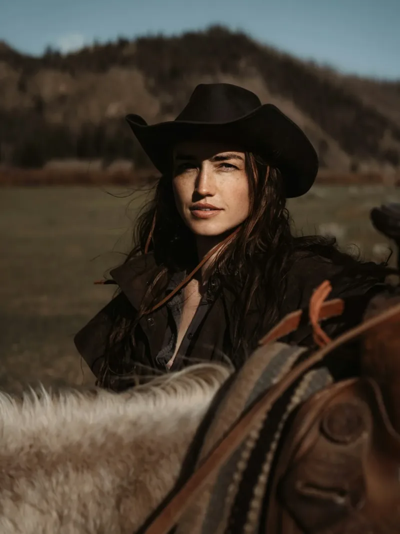 Black felt cowgirl hat three-quarter view on horseback