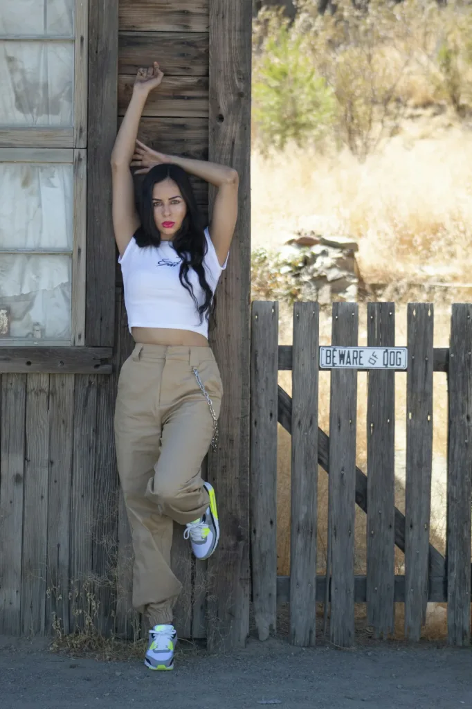 Cowgirl baby tee full look by a ranch gate
